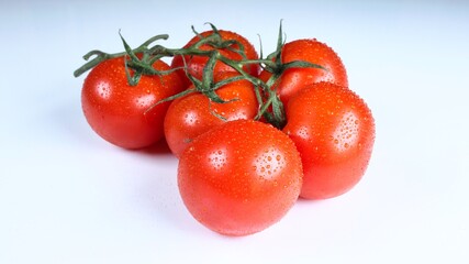 tomatoes with water-drops on turntale with white background