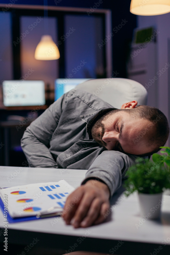 Poster manager napping on desk because of overwork in workplace. workaholic employee falling asleep because