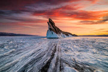 Rock on Lake Baikal in winter at dawn. Winter travel in Russia