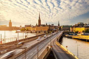 Fototapeta premium Scenic panoramic view of Gamla Stan, view of old buildings and car traffic at the bridge Stockholm, Sweden