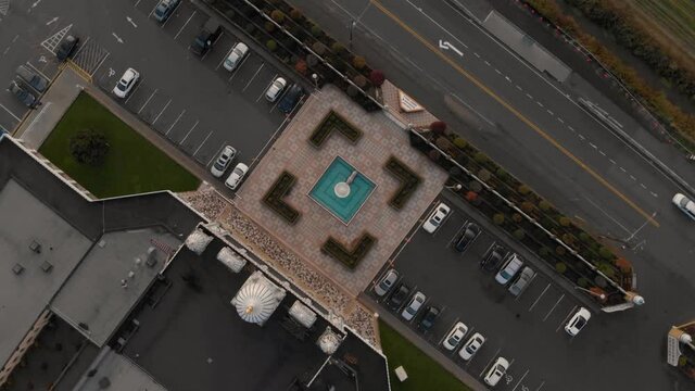 Drone 4K Footage top rotating shot of Hindu temple with beautiful and elaborate sculpture and symmetrical architecture in the middle of a farmland slowly Rotating ascending bird's eye view