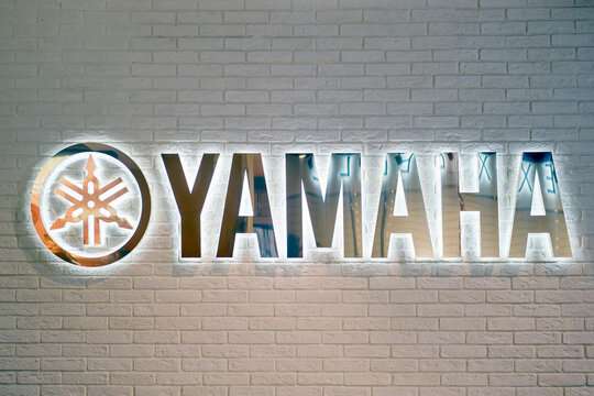Yamaha music brand lettering and logo on white brick wall - Moscow, Russia, January 27, 2021