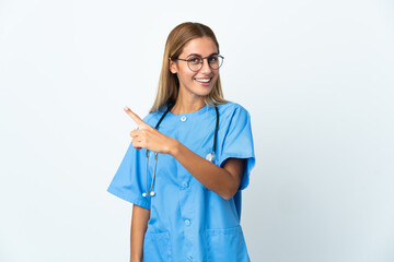 Surgeon doctor woman over isolated white background pointing to the side to present a product