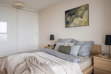 Fototapeta na wymiar Cozy bedroom with big bed and wardrobe