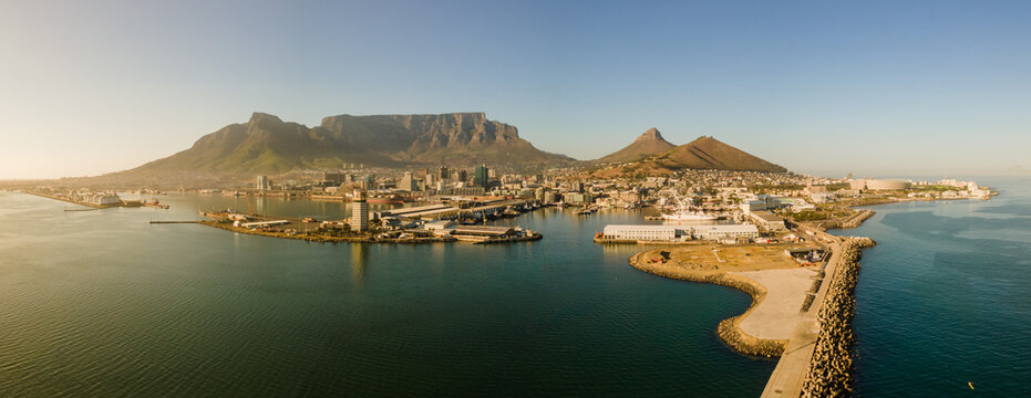 Panoramic aerial view of V & A Waterfront foreshore, Cape Town Stadium and Table Mountain sunrise in summer from Atlantic Seaboard, Sea Point, Cape Town, South Africa