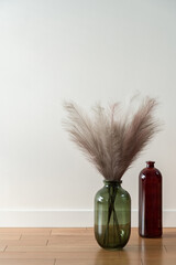 Two decorative vases on wooden floor