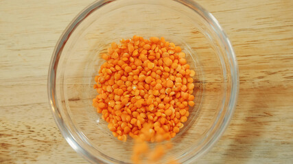 Pouring yellow lentils into a bowl. Close up shot