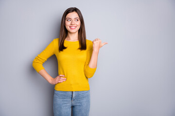 Photo of strict brunette nice lady look point empty space wear yellow sweater isolated on grey...
