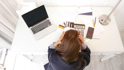Selective focus of businesswoman felling an headache  and stressed  which she is depressed of the financial problem with bill of credit card in the office