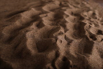 the texture of beach sand in the rays of light