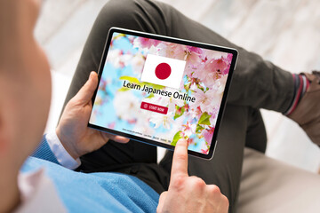 Man taking online courses and learning Japanese language