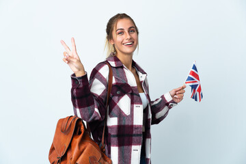 Young woman holding an UK flag isolated on white background smiling and showing victory sign