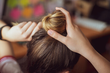 Fototapeta premium Woman collecting hair in hair salon