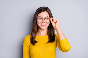 Portrait of pretty cheerful content girl touching specs good healthy vision isolated over grey...