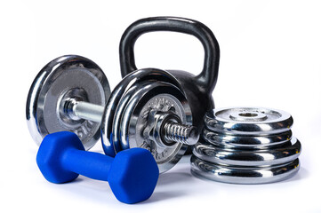 Obraz na płótnie Canvas black kettlebell with blue and silver dumbbells and dumbbell pancakes on a white isolated background