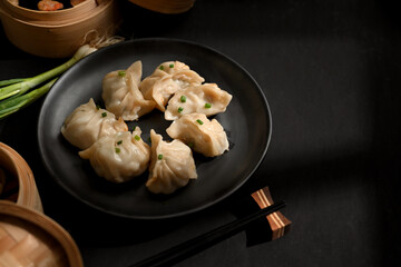 The table with plat and bamboo steamer of Dimsum dumplings and copy space