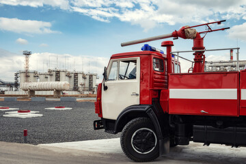 A fire truck is on duty at an oil refinery