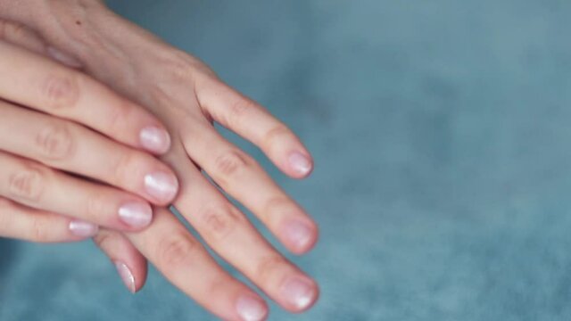 Arms of young woman applying cream. Beautiful female hands studio close-up. Anti-aging, healthcare and rejuvenation