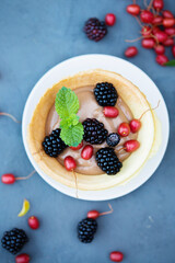 dessert with berries in a crispy waffle edible plate
