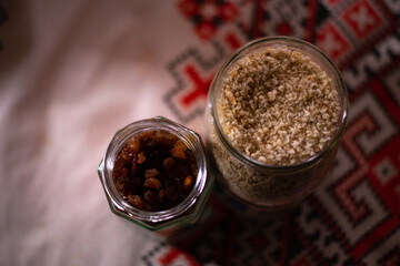 ground walnuts and raisins in a jar. natural ingredients for cakes