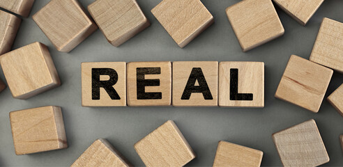 REAL - word concept from wooden blocks. Top view