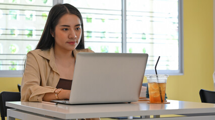 Portrait of businesswoman working with laptop on the table