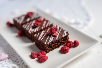 rich dark cocolate brownie cake desert with freeze dried raspsberries  - 416000458