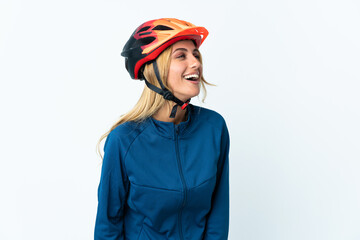 Young blonde Uruguayan cyclist woman isolated on background laughing