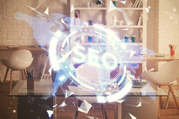Double exposure of SEO drawing and office interior background. Concept of Search optimization...