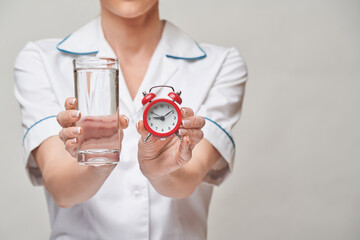 Healthy eating or lifestyle concept - female woman doctor holding and a glass of clear fresh...