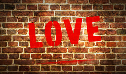 Love spray painted inscription on the brick wall