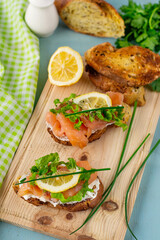 Bruschetta with smoked salmon, cheese, lettuce and chives