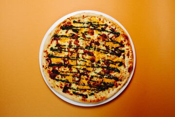 Top view pizza with mushrooms and tomatoes on a green-red background