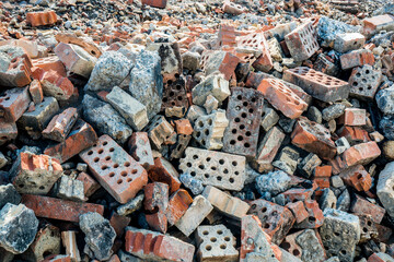 Debris of a destroyed brick fabric which has burned down to its foundation.