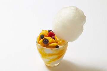 Cotton candy on top of mango raspberry ice cream