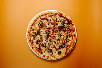 Top view pizza with mushrooms and tomatoes on a green-red background