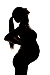 Fototapeta premium silhouette of a young pregnant woman