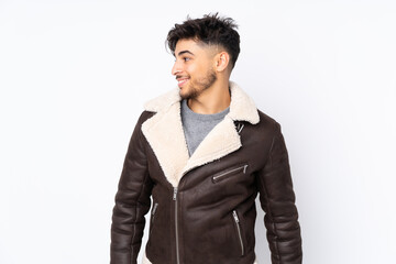 Arabian handsome man over isolated background looking to the side and smiling
