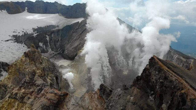 Aerial top view of fumaroles in crater of active Mutnovsky volcano, Kamchatka