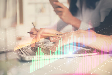 Multi exposure of woman hands typing on computer and financial graph hologram drawing. Stock market analysis concept.