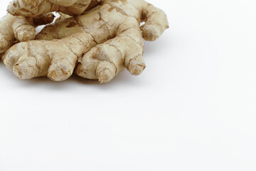Fresh ginger on a white isolated background - close-up photo