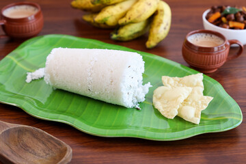 Rice Puttu white Pittu , Kadala Chickpea curry , milk tea , popular South Indian breakfast steamed rice cake Kerala food Tamil Nadu India Sri Lanka. rice flour grated coconut
