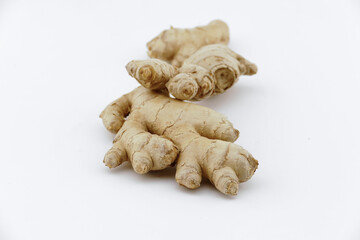 Fresh ginger on a white isolated background - close-up photo
