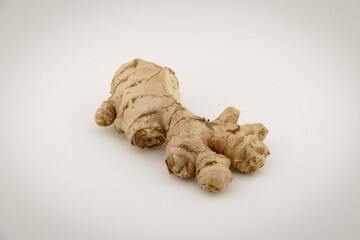 Fresh ginger on a white isolated background - close-up photo