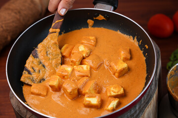Matar Paneer curry, paneer butter masala recipe made using cottage cheese, green peas, served in a bowl.  Delhi, Rajasthan India. Indian veg curry wooden background. side dish of Roti, Chapati, naan