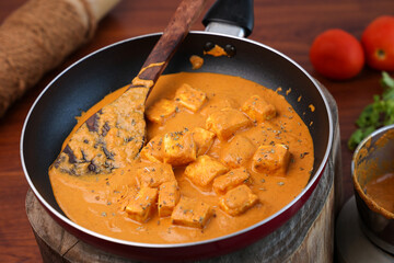 Matar Paneer curry, paneer butter masala recipe made using cottage cheese, green peas, served in a bowl.  Delhi, Rajasthan India. Indian veg curry wooden background. side dish of Roti, Chapati, naan