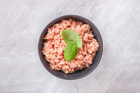 Raw minced meat in bowl on wooden table