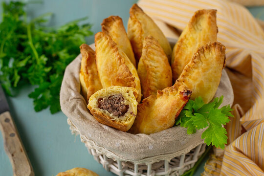 Traditional Lithuanian savoury pastries Kibinai filled with ground meat and onions