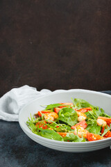 Salad of shrimp prawn and fresh vegetable, leaves of arugula, lettuce.