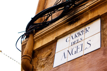 View of Sign „Carrer Dels Angels“ in Spanish in the City of Pollenca, Mallorca, Spain 2019 - 416011427